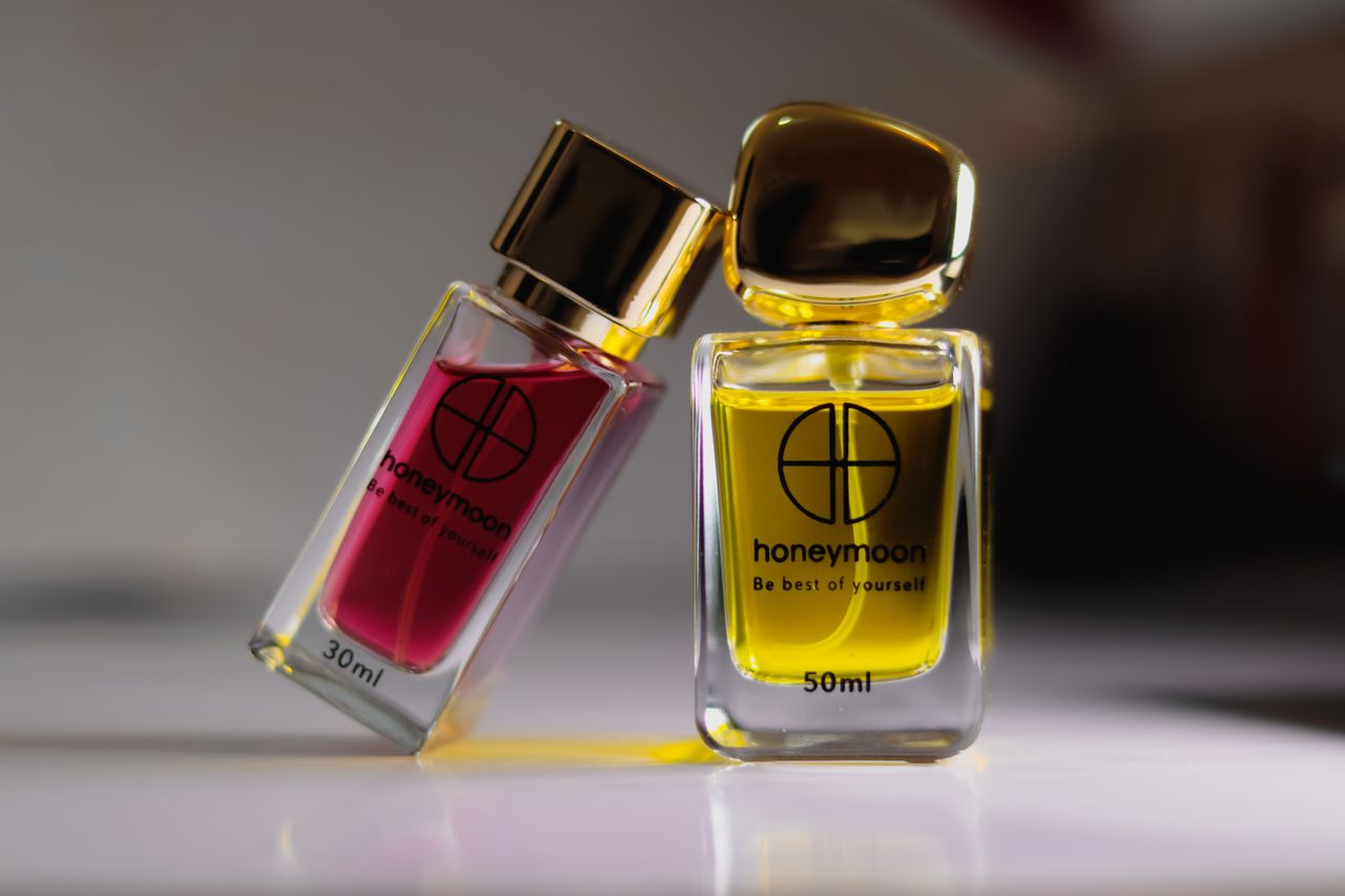 Offerings Close-up of luxury perfume bottles with gold caps on a white surface, ideal for product photography.