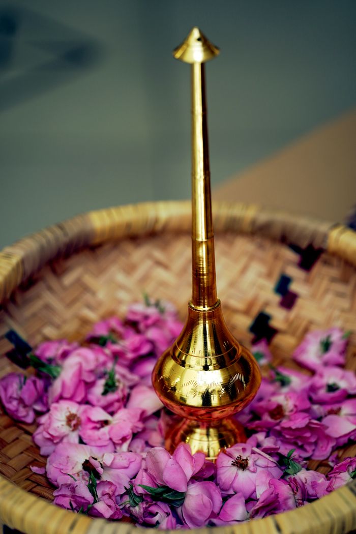 Offerings Golden incense burner surrounded by pink rose petals in Dammam, Saudi Arabia.